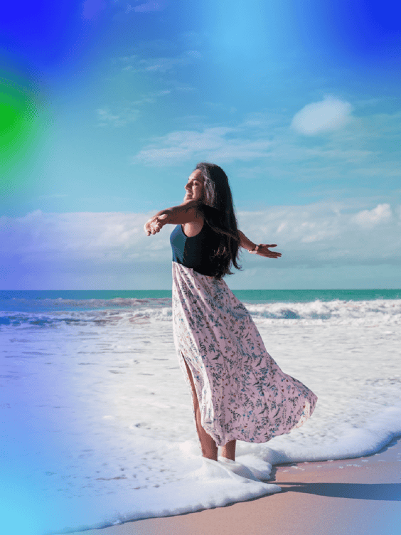 woman-on-beach-arms-open-successful-left-facing